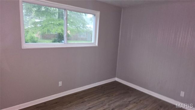 Empty room featuring dark wood-style flooring and baseboards | Image 13