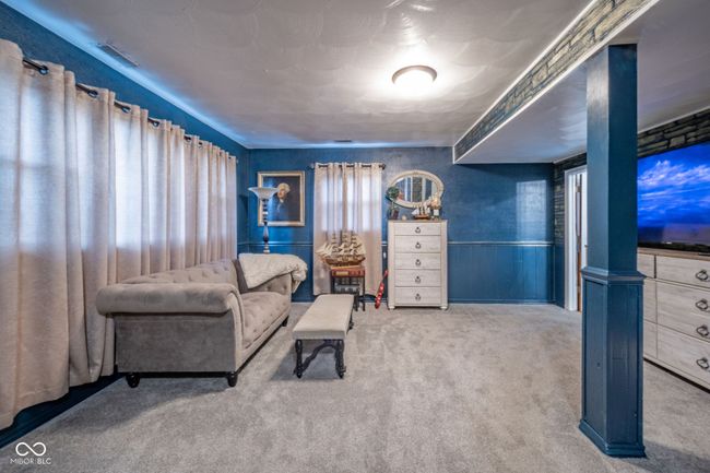 sitting room featuring visible vents, carpet, and a wainscoted wall | Image 10