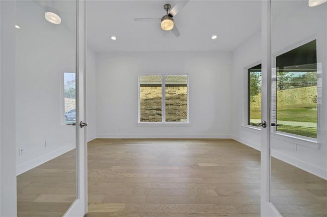 Expansive office featuring elegant double French doors. | Image 13