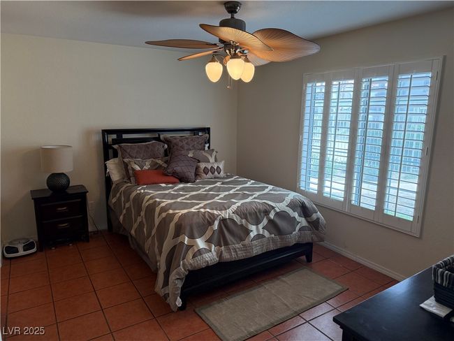 Tiled bedroom with ceiling fan and multiple windows | Image 7