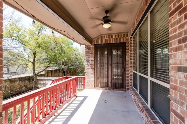 View of patio featuring a ceiling fan and fence | Image 35