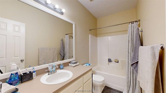 Full bath with shower / bath combination with curtain, toilet, and vanity | Image 18