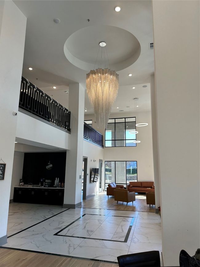 Common area with recessed lighting and a towering ceiling | Image 18