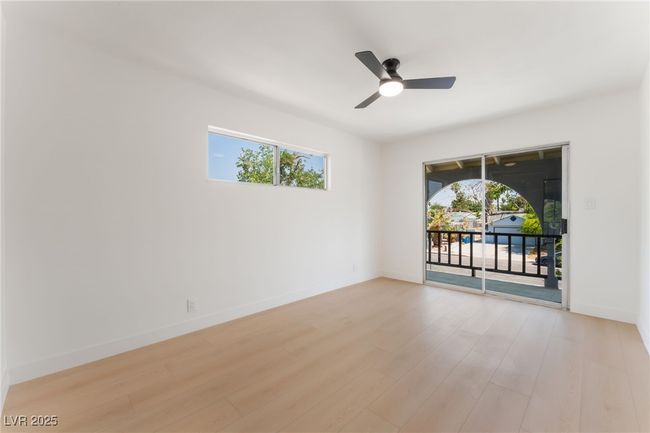 Spare room featuring light wood-style flooring and ceiling fan | Image 27