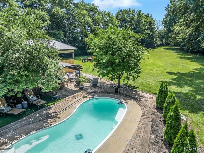 Outdoor pool featuring a gazebo, a patio area, a yard, and view of scattered trees | Image 18