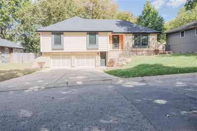 View of front of home with a front yard and a garage | Image 1