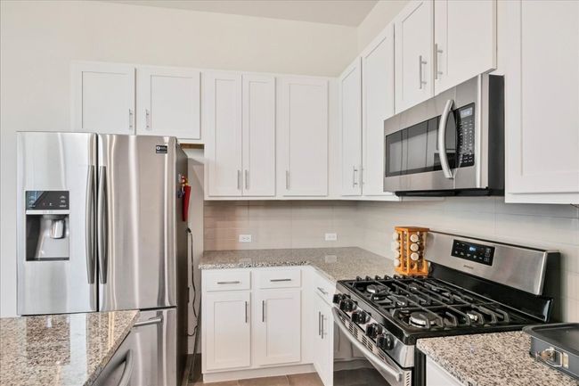 The spacious kitchen has lovely design. | Image 12