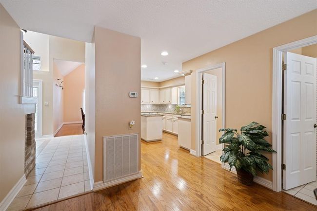 View from the breakfast nook, looking toward the entryway and kitchen. Doors to the powder room and laundry room are on the right. | Image 19