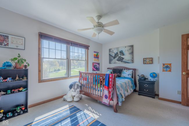 carpeted bedroom featuring baseboards and ceiling fan | Image 24