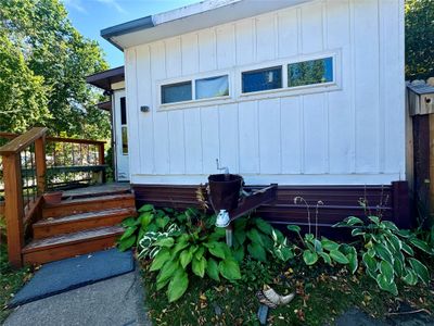 View of side of property with a wooden deck | Image 3