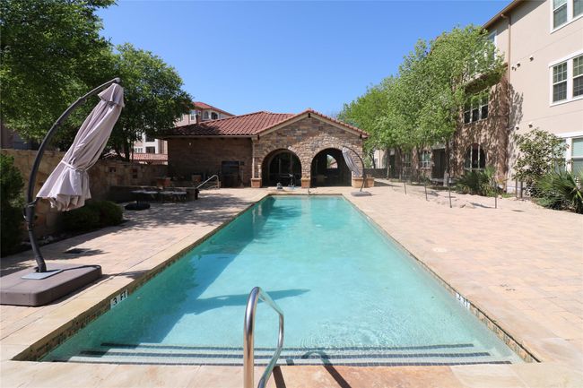 View of pool featuring a patio area and fence | Image 30