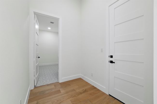 Hallway featuring light wood-style flooring, baseboards, and visible vents | Image 17