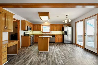 Kitchen with a center island, appliances with stainless steel finishes, dark hardwood / wood-style floors, and plenty of natural light | Image 3