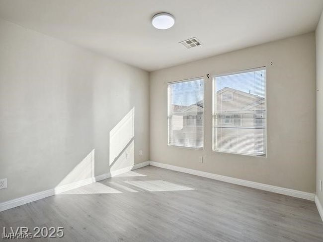 Spare room featuring baseboards and light wood-style flooring | Image 5