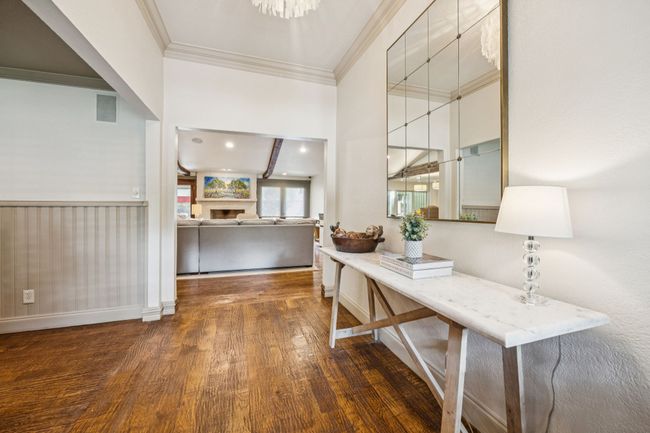 Welcoming entry with wood flooring and views of the dining and living room. | Image 14