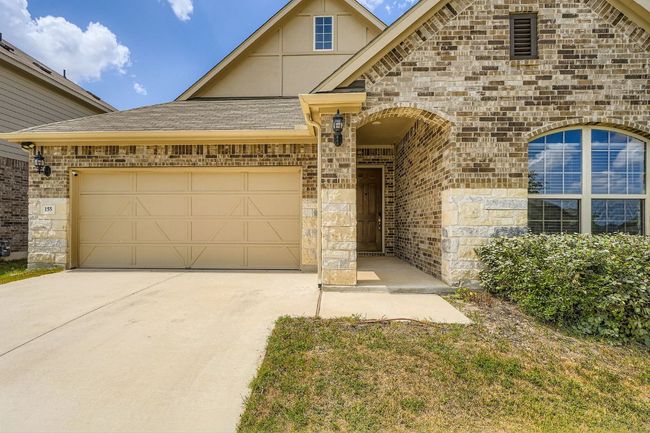 View of front of property featuring brick siding, driveway, a garage, and a shingled roof | Image 4