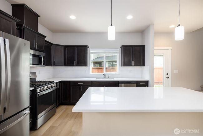 Quart countertops in the kitchen. | Image 9