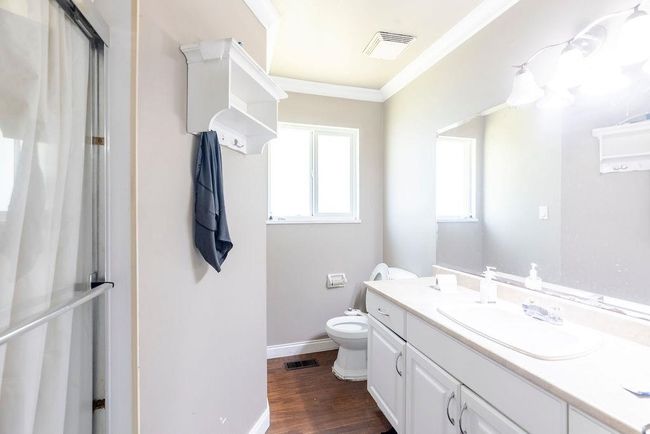 Full bathroom with vanity, ornamental molding, and wood finished floors | Image 14