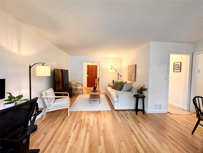Living area featuring light wood-type flooring and baseboards | Image 6