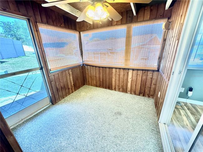 Screened porch with storage closet. Door to outside and glass door to living room | Image 24