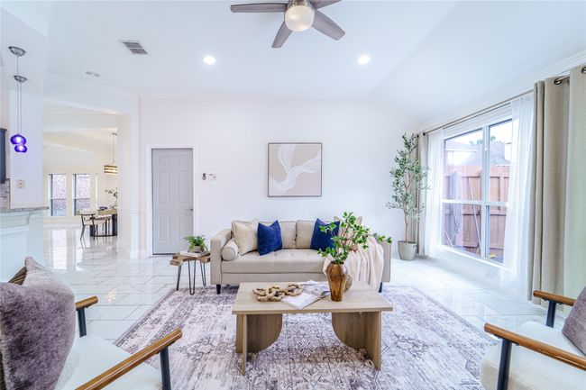 Living area with a ceiling fan, vaulted ceiling, ornamental molding, and recessed lighting | Image 16
