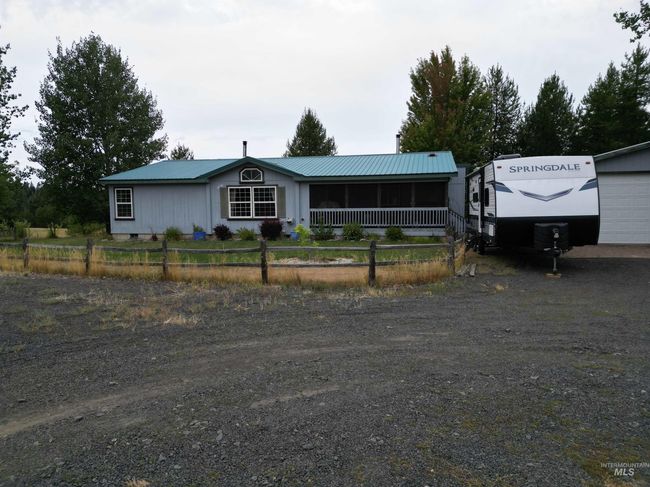 Single story home featuring a metal roof and a garage | Image 15