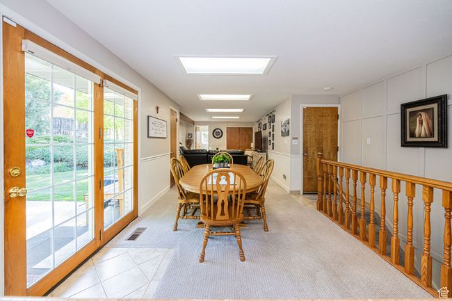 Dining room featuring visible vents, light carpet, and a decorative wall | Image 20
