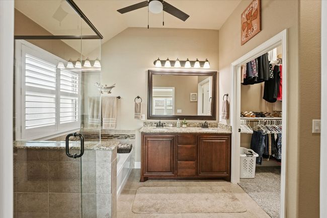 Full bathroom with a shower stall, a sink, a bath, a spacious closet, and ceiling fan | Image 20