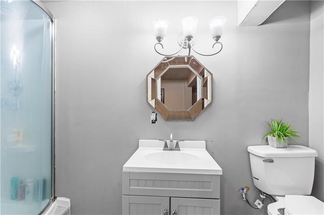 Bathroom featuring toilet, a shower stall, and vanity | Image 30