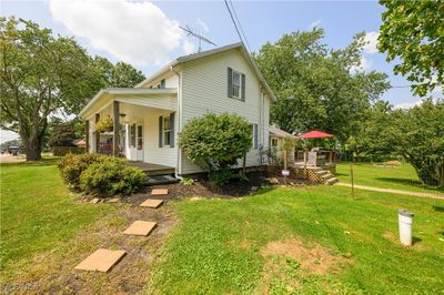 Rear view of property featuring a lawn | Image 2