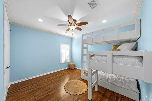 Bedroom featuring ornamental molding, baseboards, recessed lighting, wood finished floors, and a ceiling fan | Image 25