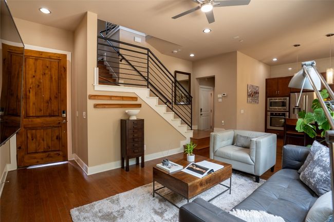 Living room with stairs, ceiling fan, hardwood / wood-style floors, and recessed lighting | Image 5