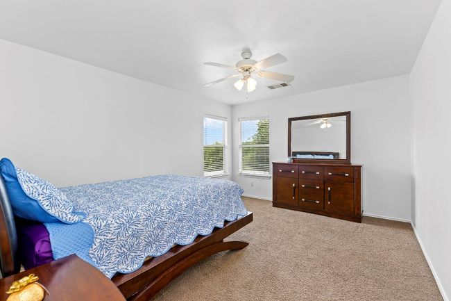 Carpeted bedroom featuring baseboards and a ceiling fan | Image 28