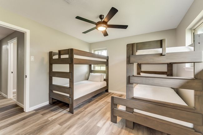 Bedroom with wood finished floors and ceiling fan | Image 28