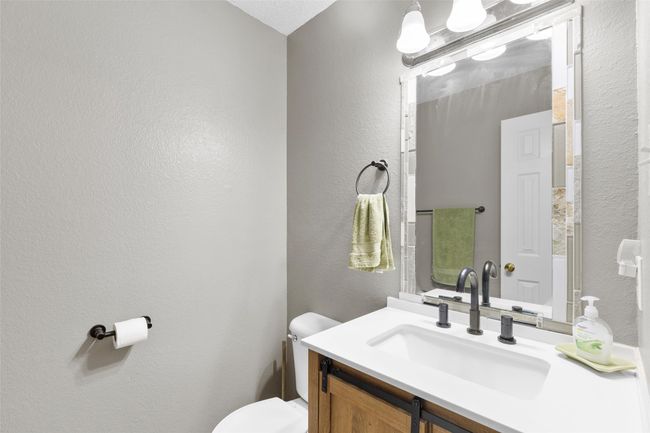 Half bath featuring a textured wall and vanity | Image 11