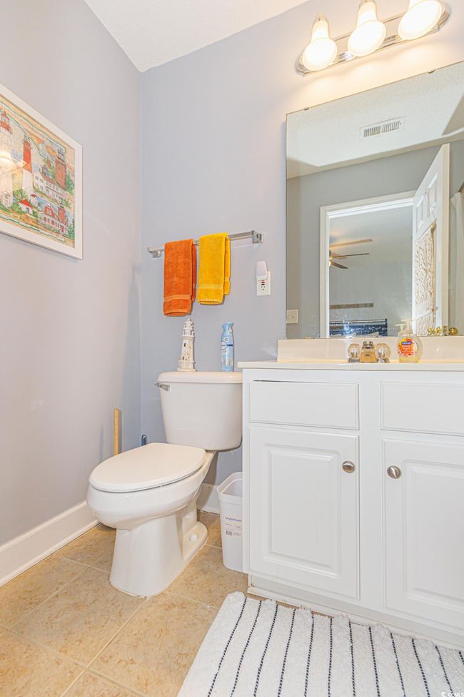 Bathroom featuring vanity, toilet, and tile patterned flooring | Image 23