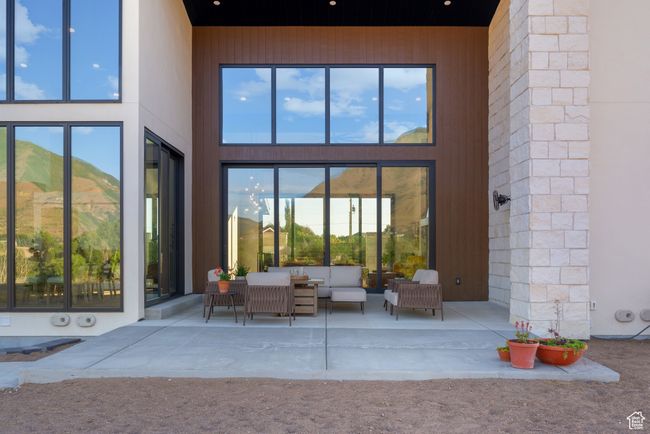 View of exterior entry with outdoor lounge area and a patio area | Image 79