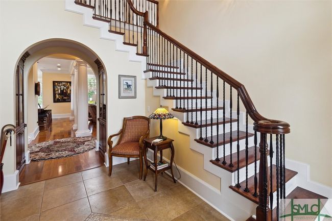 Your guests are greeted with this two story foyer and impressive staircase. | Image 4