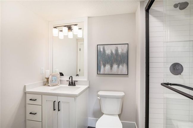 Bathroom with a tile shower and vanity | Image 30