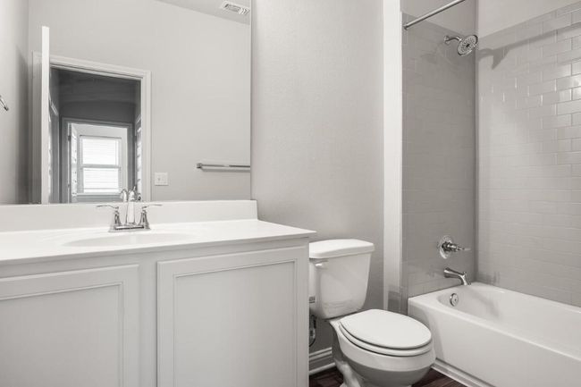 Full bathroom with toilet, vanity, and shower / washtub combination | Image 13