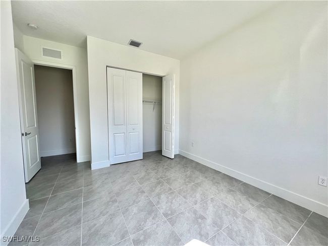 Unfurnished bedroom featuring a closet and light tile patterned flooring | Image 21