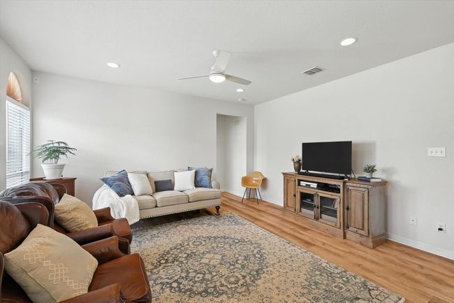 Living room featuring light wood finished floors, a ceiling fan, and recessed lighting | Image 10