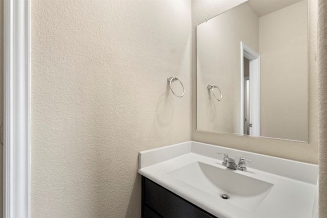 Bathroom featuring vanity and a textured wall | Image 24