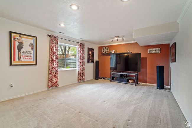 Living area featuring visible vents, ornamental molding, carpet flooring, and baseboards | Image 20