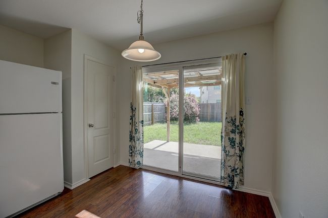 Unfurnished dining area featuring dark wood finished floors and baseboards | Image 23