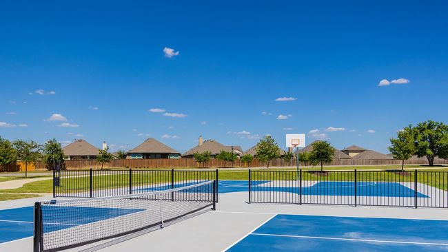 View of sport court featuring community basketball court, fence, a tennis court, and a lawn | Image 9