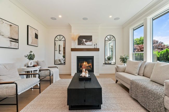 Living room featuring ornamental molding, a fireplace, and wood finished floors | Image 10