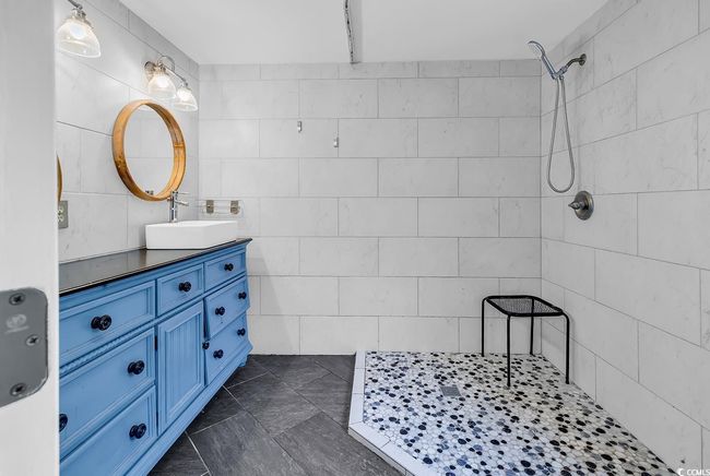 Unfurnished bedroom with a textured ceiling, wood finished floors, lofted ceiling, baseboards, and ceiling fan | Image 13