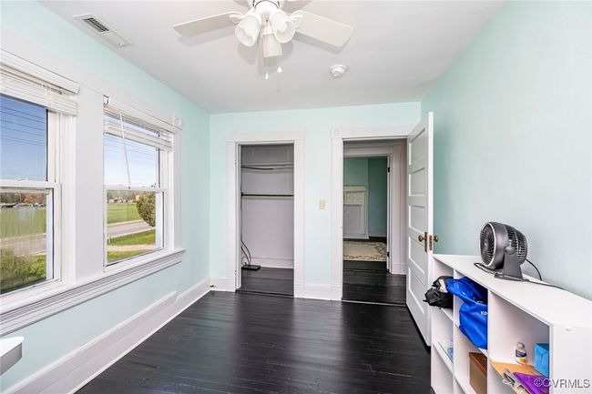 Bedroom featuring baseboards, a ceiling fan, and visible vents | Image 19