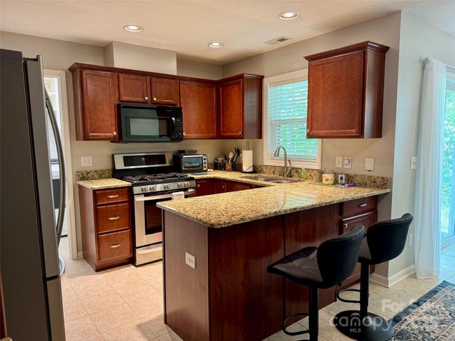 Kitchen includes stainless appliances, granite countertops | Image 8